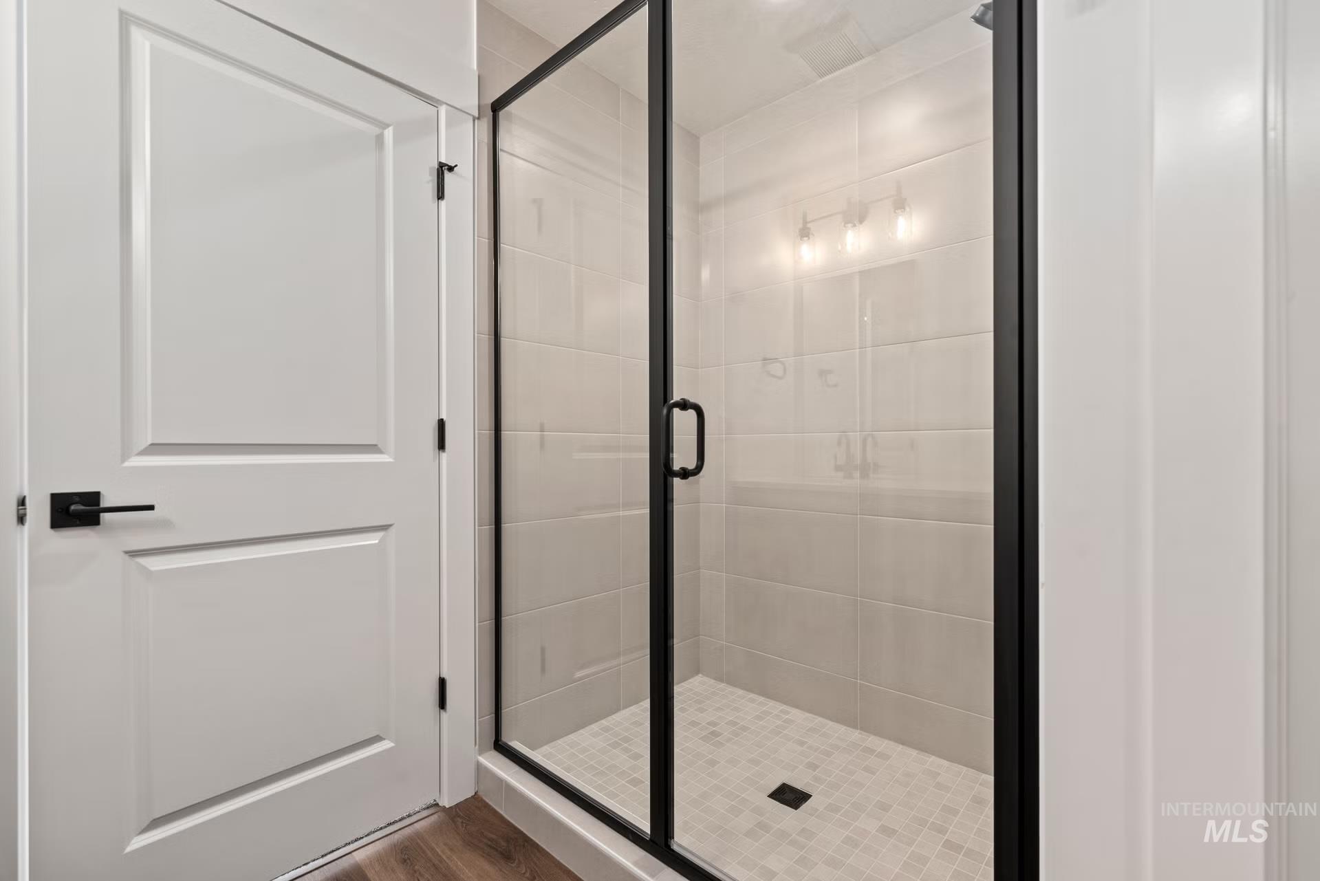 748 South Calhoun Place Star, ID 83669 - Photo 27 of 32 Full bathroom with a shower stall and dark wood-style floors