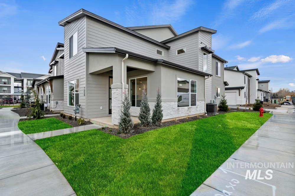 748 South Calhoun Place Star, ID 83669 - Photo 30 of 32 View of side of property with a porch, a yard, a residential view, and stone siding