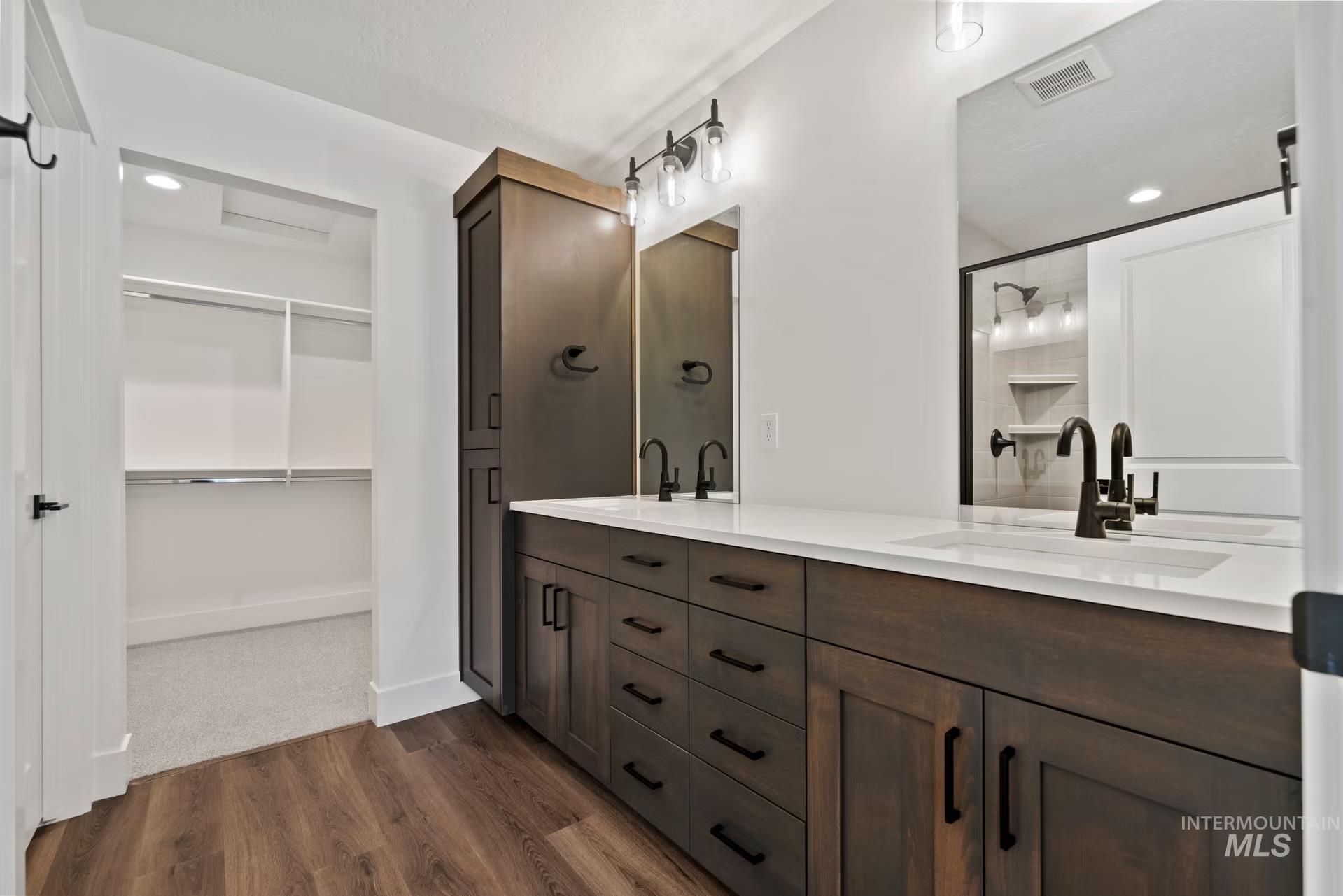 748 South Calhoun Place Star, ID 83669 - Photo 4 of 32 Full bath featuring double vanity, a walk in closet, recessed lighting, dark wood-type flooring, and a shower