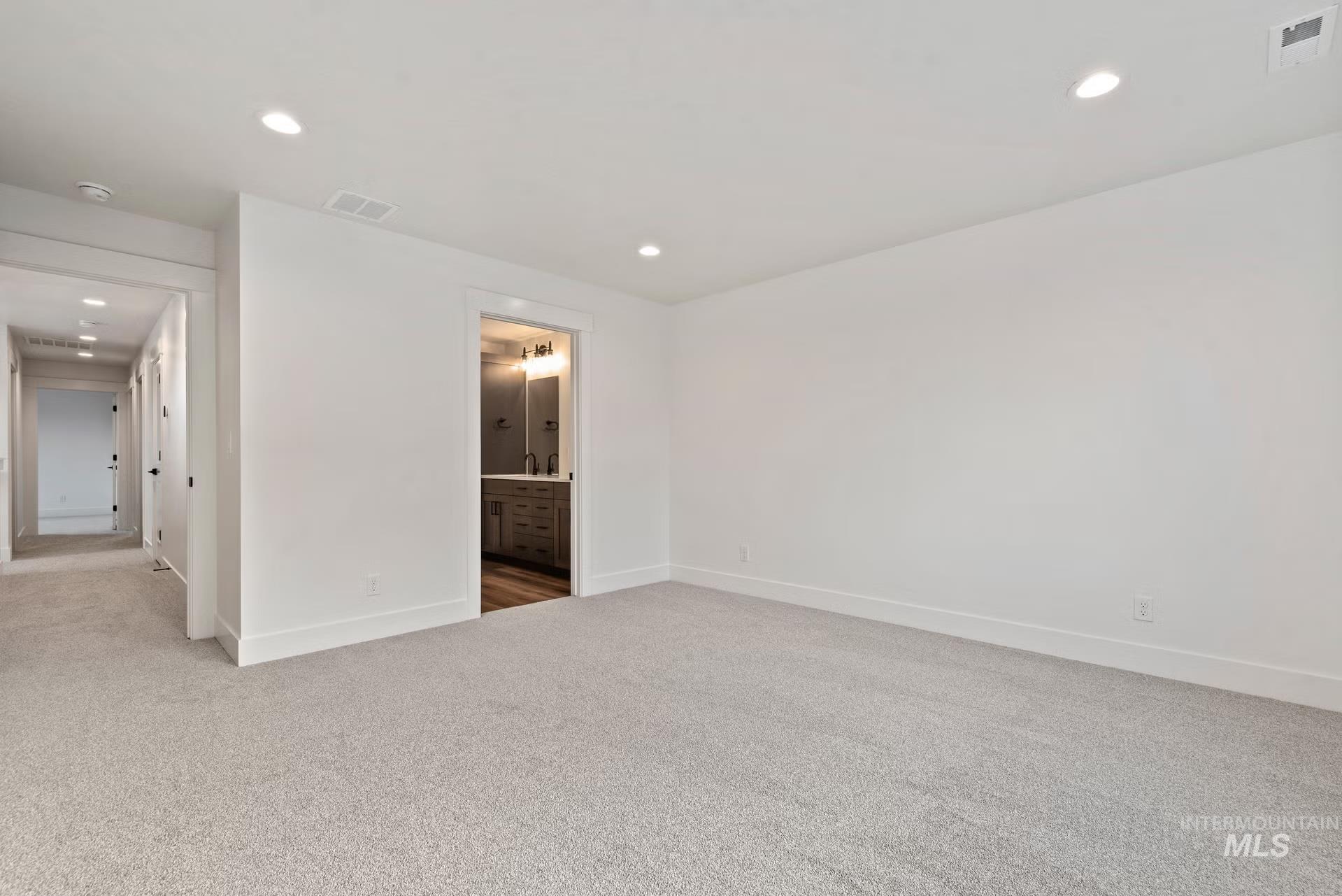 748 South Calhoun Place Star, ID 83669 - Photo 5 of 32 Carpeted spare room with baseboards and recessed lighting