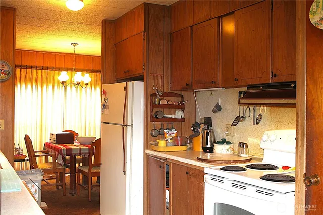 a kitchen with a refrigerator and a table