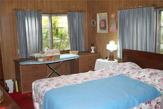 a bedroom that has a bed and a table in it