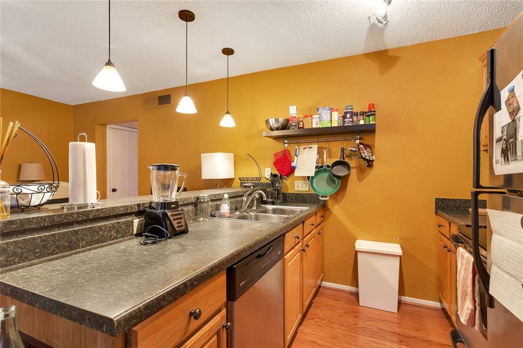 910 Duncan Lane, Unit 35 Austin, TX 78705 - Photo 8 of 20 A well-lit kitchen with ample counter space and convenient pendant lighting.