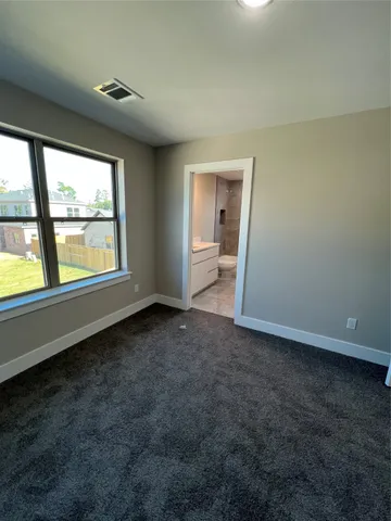 an empty room with large windows and mountain view
