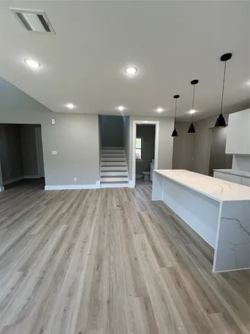 a view of a hallway with a kitchen