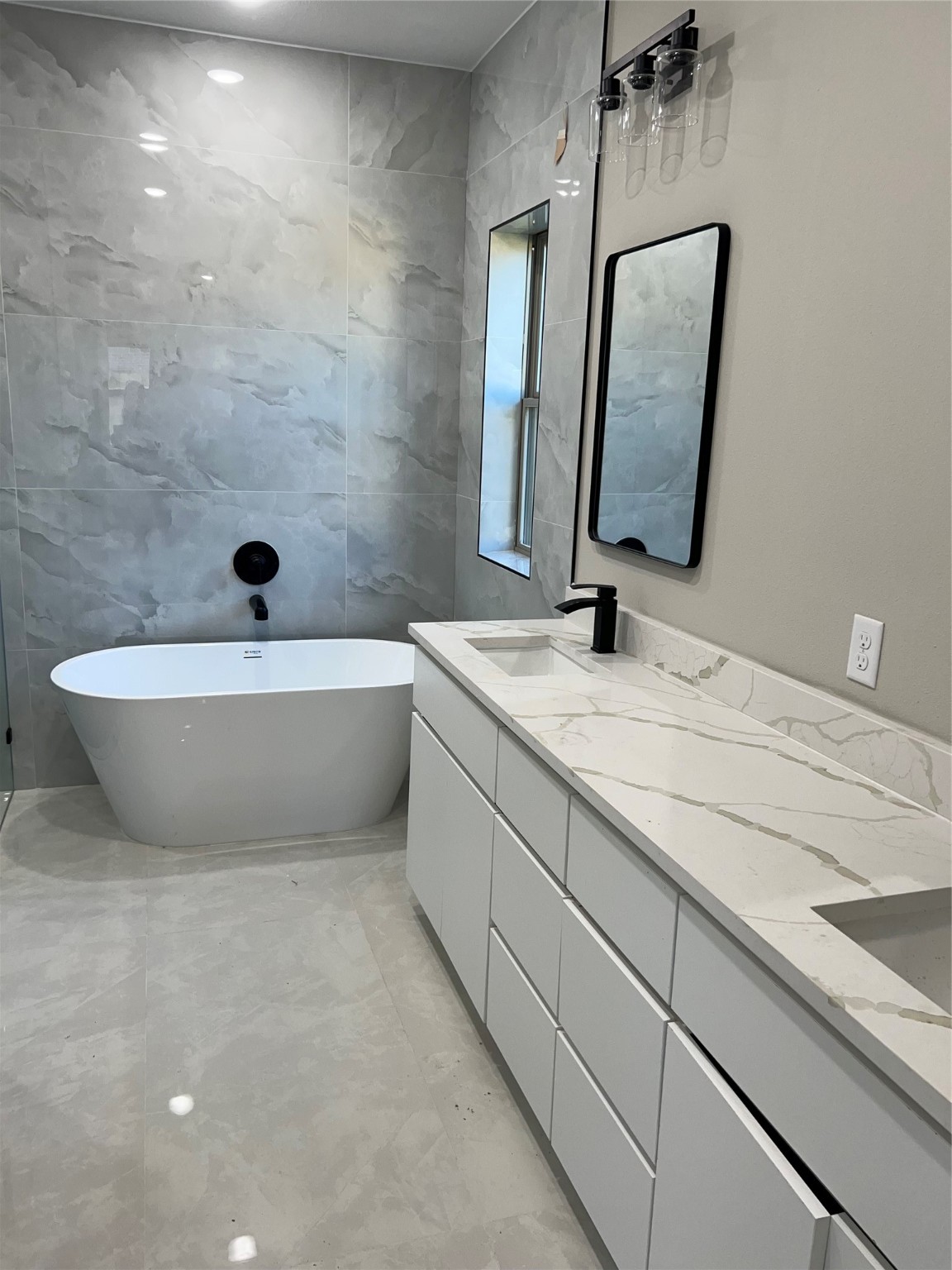 2511 Martinas Ct Spring Spring, TX 77388 - Photo 25 of 30 a bathroom with a double vanity sink mirror and bathtub