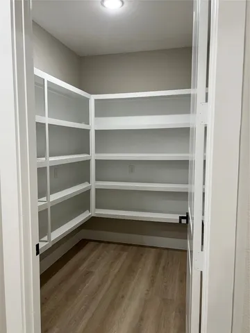 a open kitchen with white cabinets stainless steel appliances a sink and a refrigerator