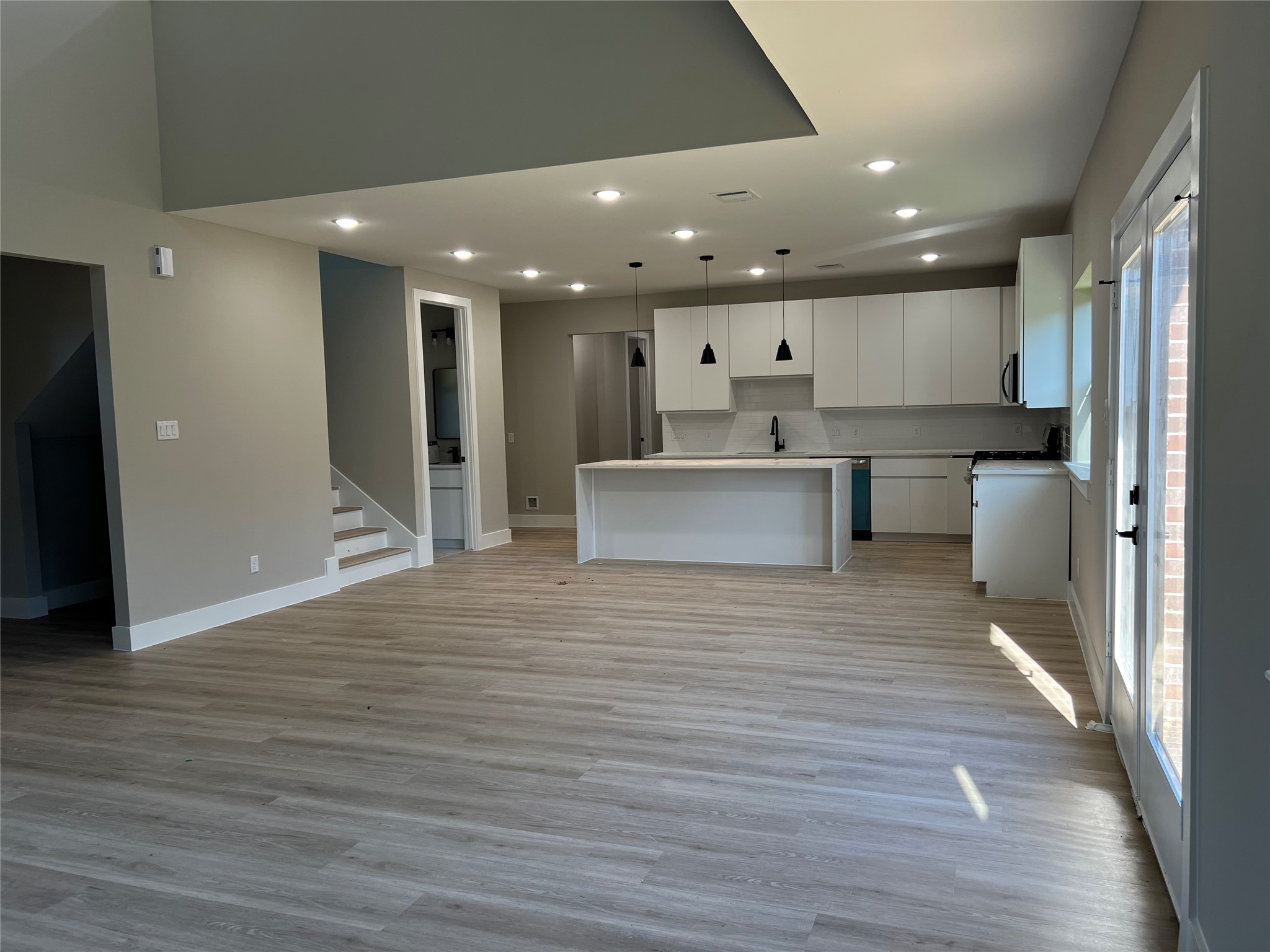 2511 Martinas Ct Spring Spring, TX 77388 - Photo 28 of 30 a open kitchen with white cabinets stainless steel appliances a sink and a refrigerator