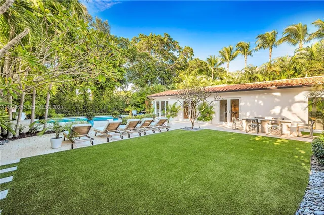a view of a house with a backyard porch and sitting area