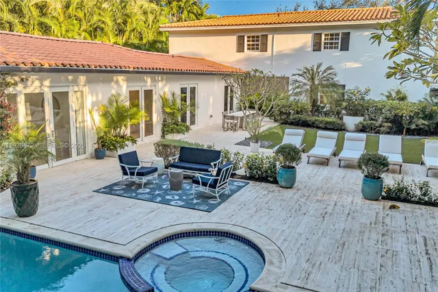 a view of a patio with table and chairs potted plants with wooden floor