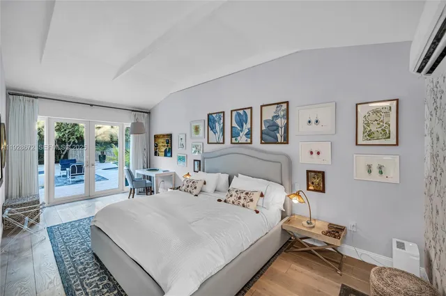 a bedroom with a bed and a large window with outer view