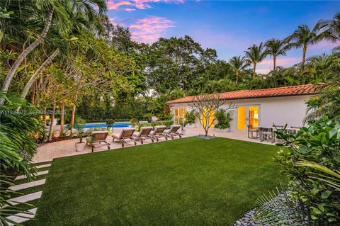 a view of backyard with seating space and green space