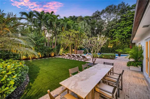 a view of a patio with table and chairs and potted plants