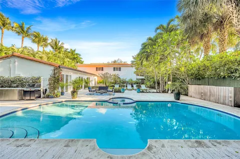 a swimming pool with outdoor seating and yard