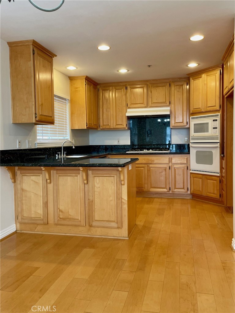 1745 Havemeyer Lane Redondo Beach, CA 90278 - Photo 8 of 20 a kitchen with granite countertop a stove a sink and a microwave