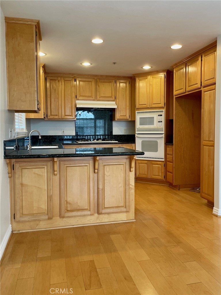 1745 Havemeyer Lane Redondo Beach, CA 90278 - Photo 9 of 20 a kitchen with stainless steel appliances granite countertop a stove a sink and a refrigerator