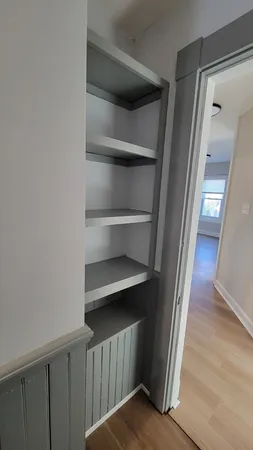 a view of a hallway with wooden floor