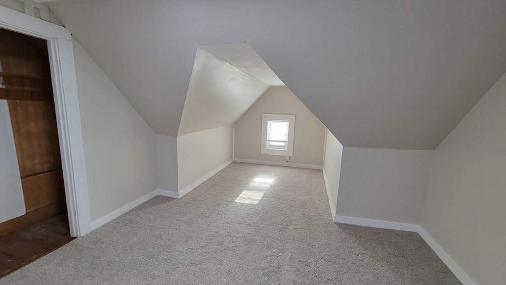 30 O'Neil Street, Unit 2 Hudson, MA 01749 - Photo 24 of 28 a view of an empty room with window and stairs