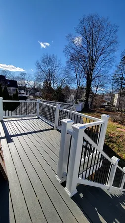 a view of balcony with wooden floor and outdoor seating