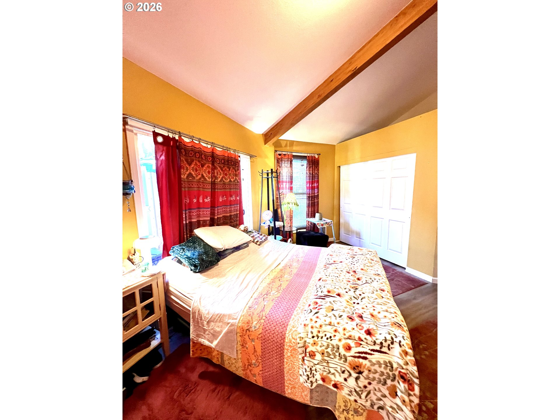 1625 Kristi Loop Lakeside, OR 97449 - Photo 17 of 41 a bedroom with a bed and a large window