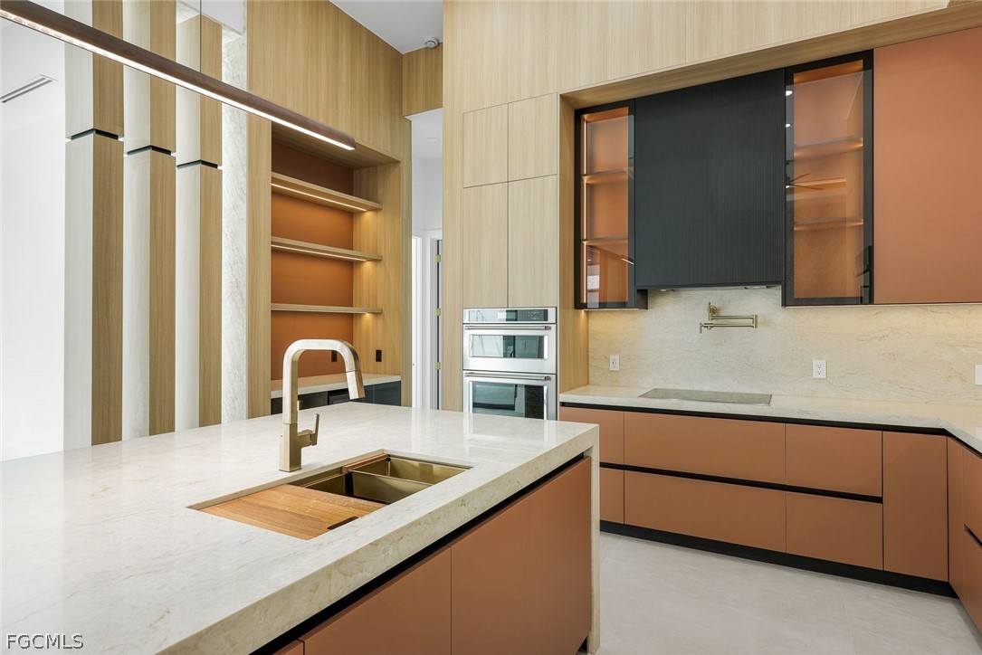 3606 Southwest 3rd Street Cape Coral, FL 33991 - Photo 12 of 47 a kitchen with a sink and a refrigerator