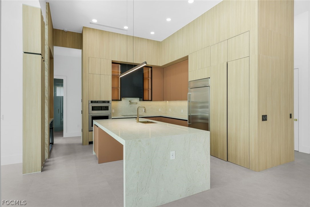 3606 Southwest 3rd Street Cape Coral, FL 33991 - Photo 14 of 47 a kitchen with stainless steel appliances a refrigerator and a stove