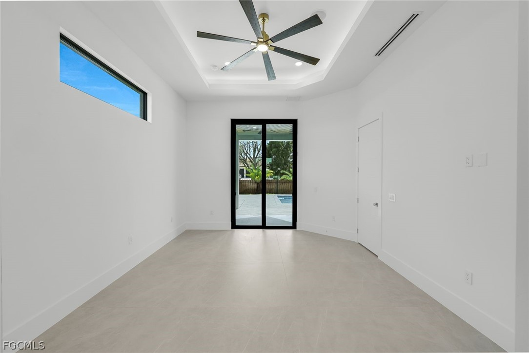 3606 Southwest 3rd Street Cape Coral, FL 33991 - Photo 24 of 47 an empty room with chandelier fan and windows