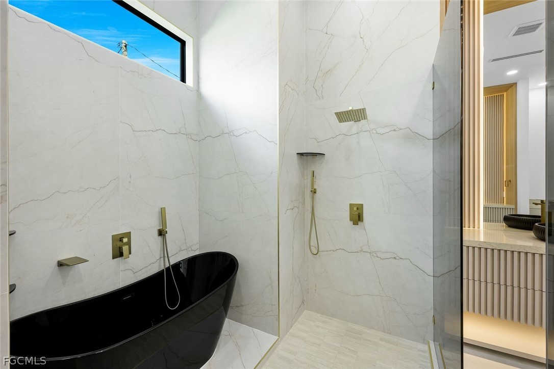 3606 Southwest 3rd Street Cape Coral, FL 33991 - Photo 28 of 47 a bathroom with a bathtub and shower