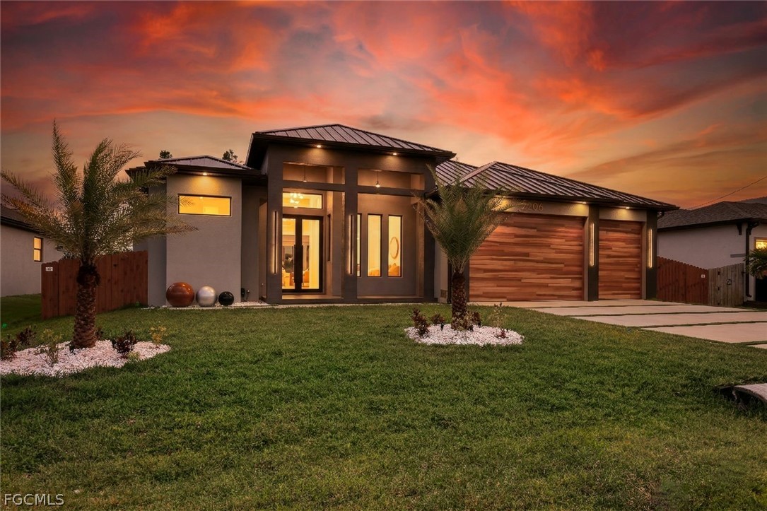3606 Southwest 3rd Street Cape Coral, FL 33991 - Photo 45 of 47 a front view of a house with a garden