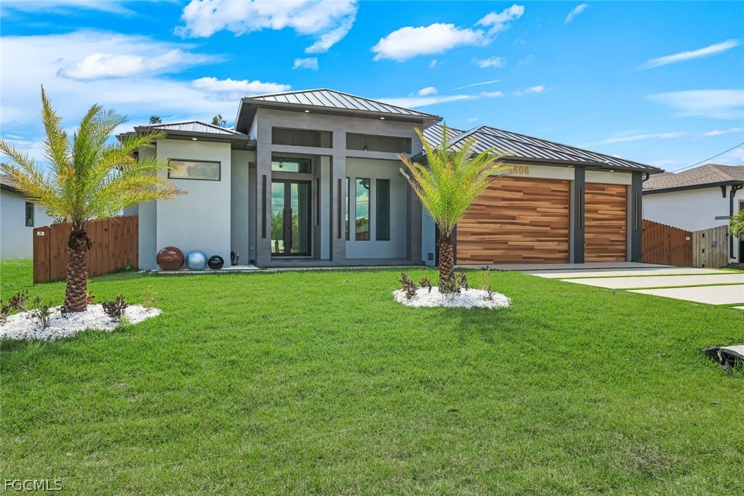 3606 Southwest 3rd Street Cape Coral, FL 33991 - Photo 5 of 47 a front view of a house with garden