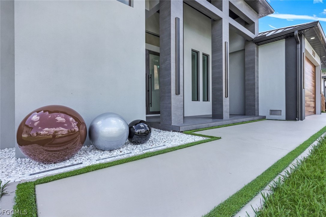 3606 Southwest 3rd Street Cape Coral, FL 33991 - Photo 6 of 47 a front view of a house with garden
