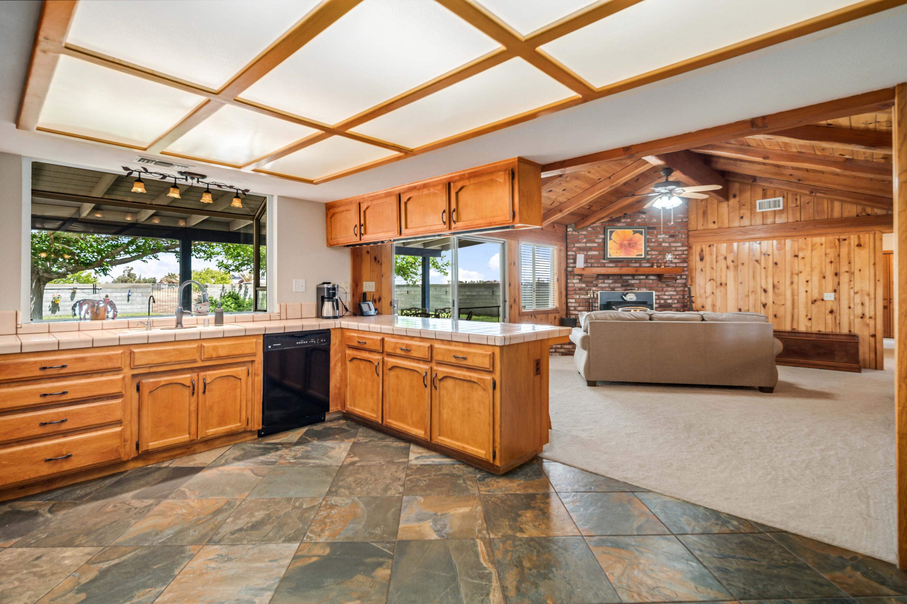 8141 Ave D-14 West Lancaster, CA 93536 - Photo 16 of 52 a kitchen with sink a stove and large windows