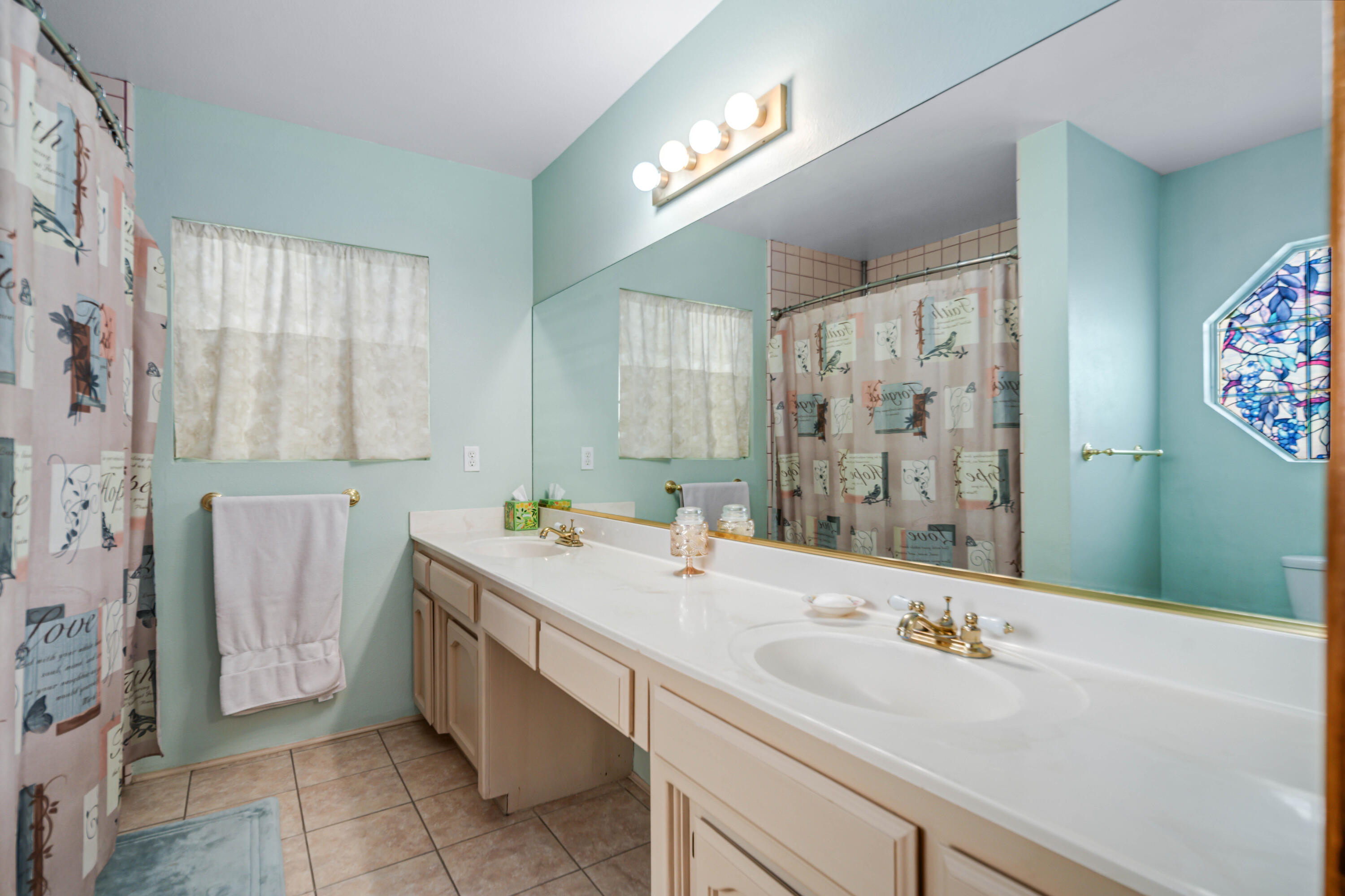 8141 Ave D-14 West Lancaster, CA 93536 - Photo 26 of 52 a bathroom with a sink double vanity and a mirror