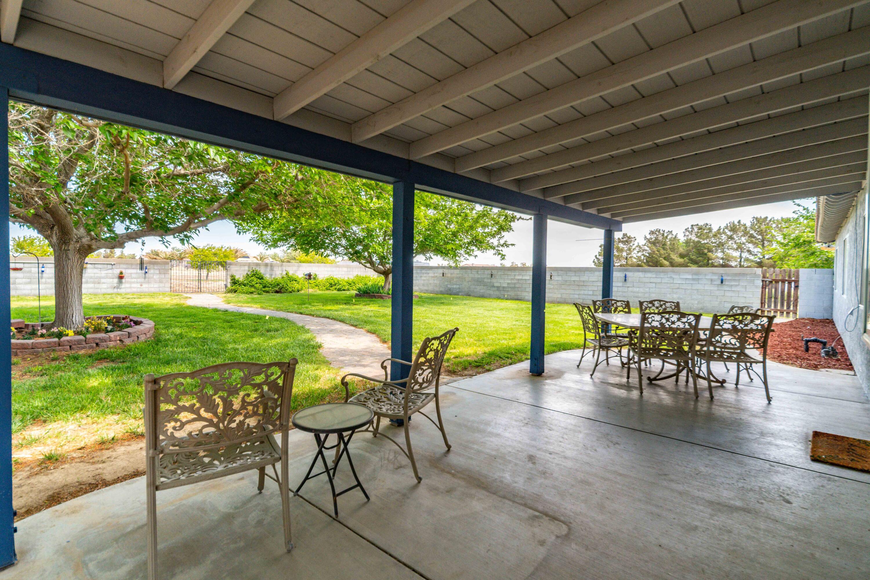 8141 Ave D-14 West Lancaster, CA 93536 - Photo 32 of 52 a view of a porch with chairs and backyard