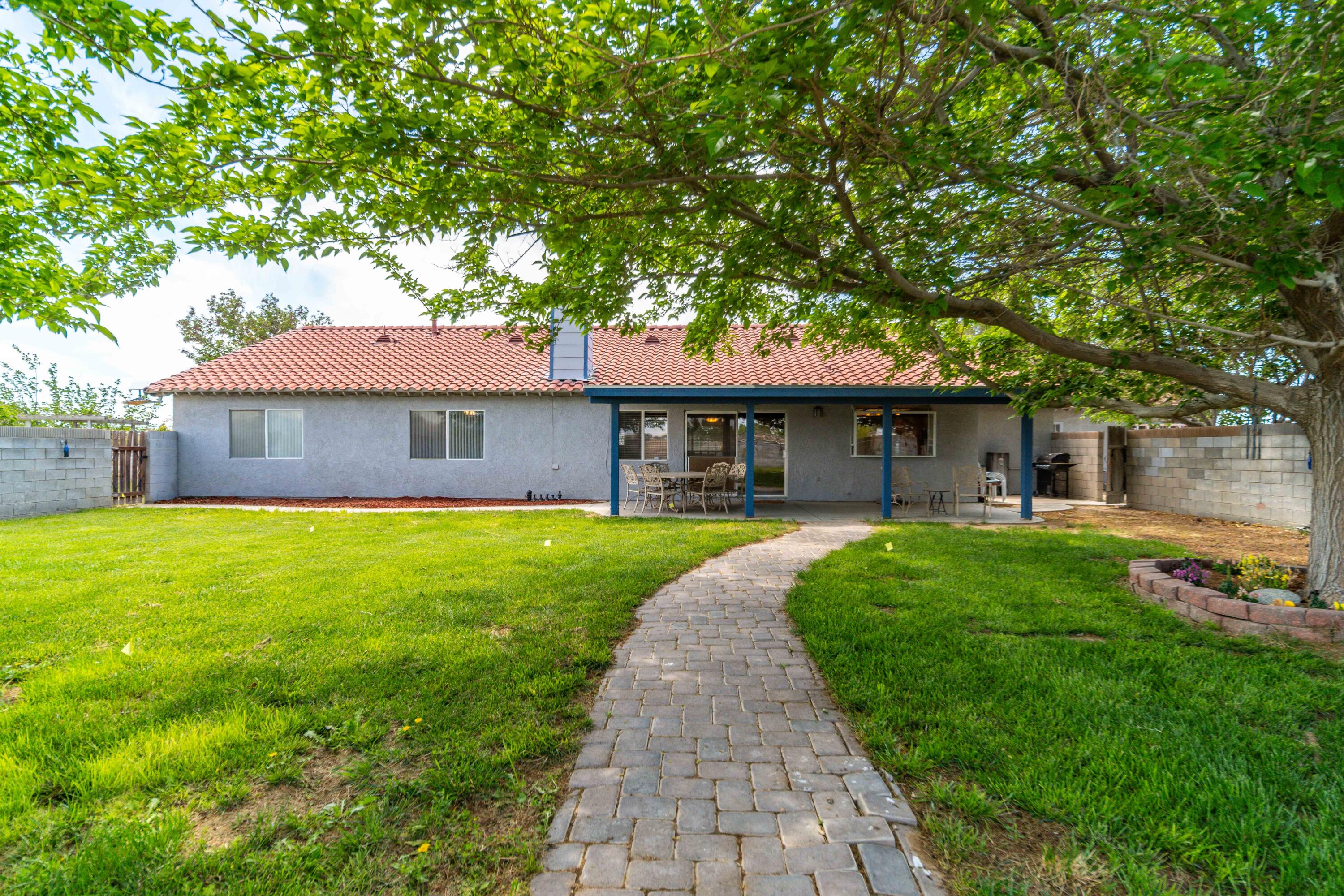 8141 Ave D-14 West Lancaster, CA 93536 - Photo 35 of 52 a front view of a house with a yard