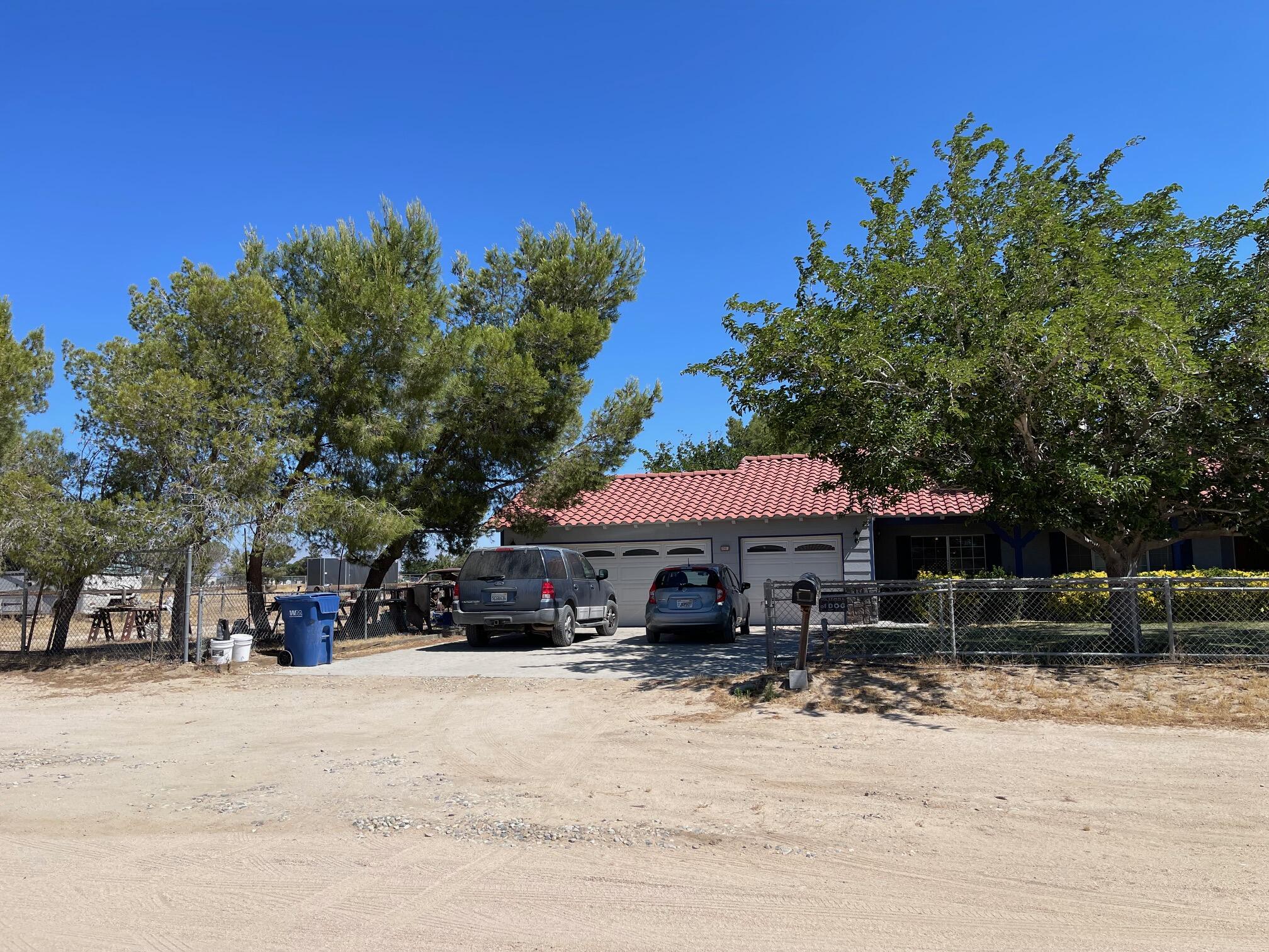 8141 Ave D-14 West Lancaster, CA 93536 - Photo 50 of 52 a swimming pool with trees in front of it