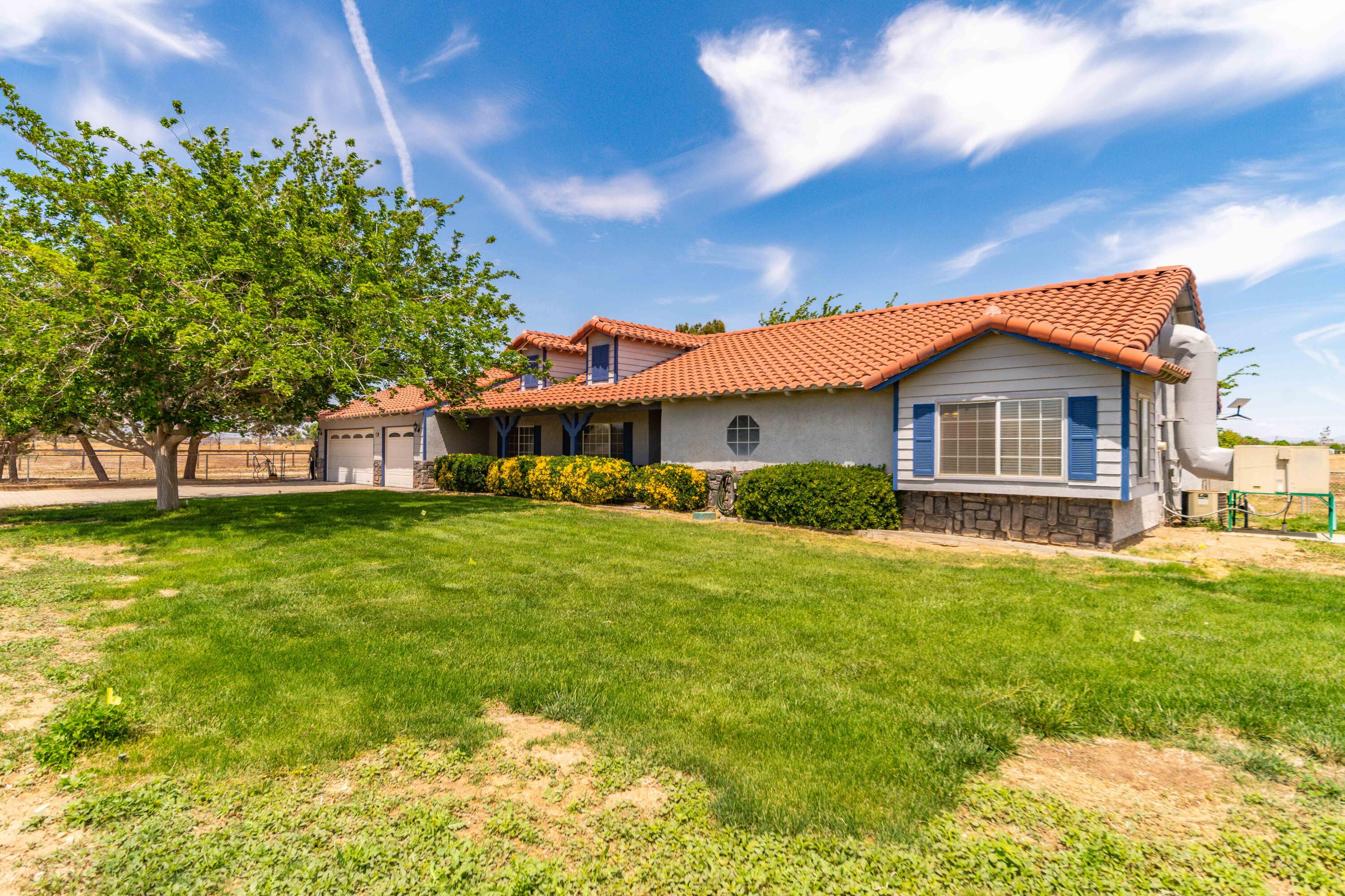 8141 Ave D-14 West Lancaster, CA 93536 - Photo 5 of 52 a front view of a house with a garden