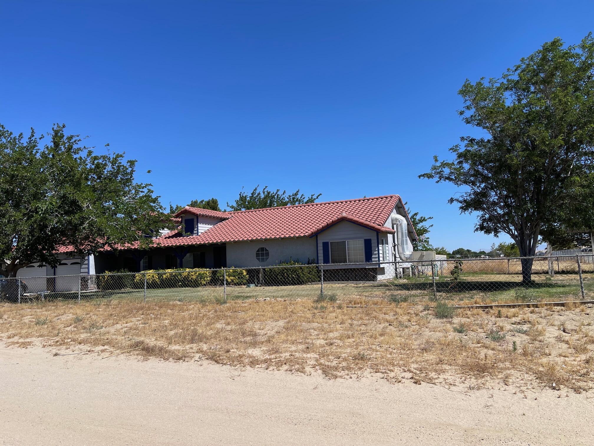 8141 Ave D-14 West Lancaster, CA 93536 - Photo 51 of 52 a front view of a house with a yard