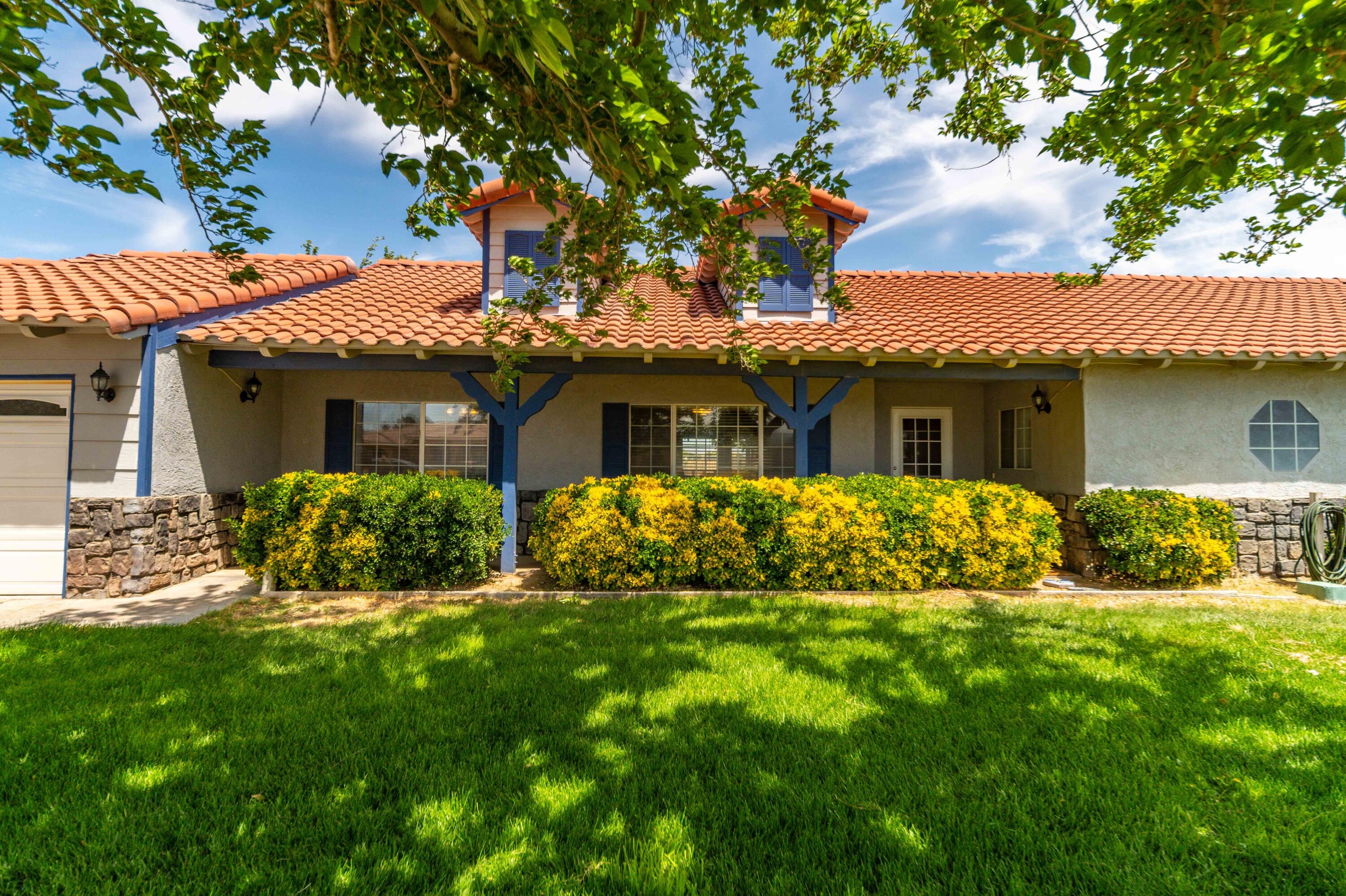8141 Ave D-14 West Lancaster, CA 93536 - Photo 6 of 52 a front view of house with yard and green space