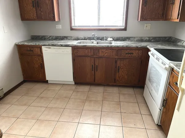 a kitchen with a sink a stove and a microwave