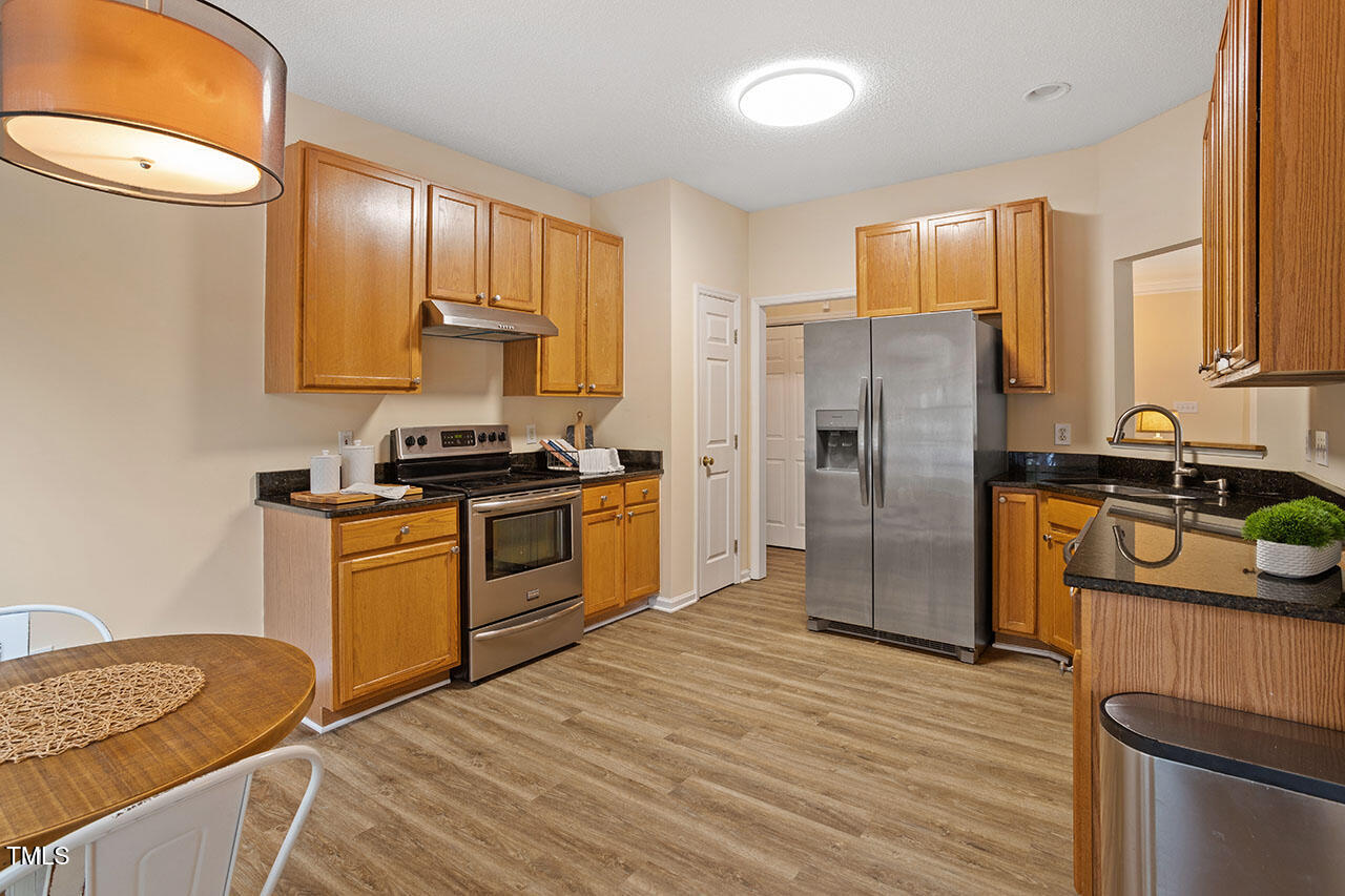 7040 Bellard Court Raleigh, NC 27617 - Photo 12 of 31 a kitchen with a refrigerator sink and stove
