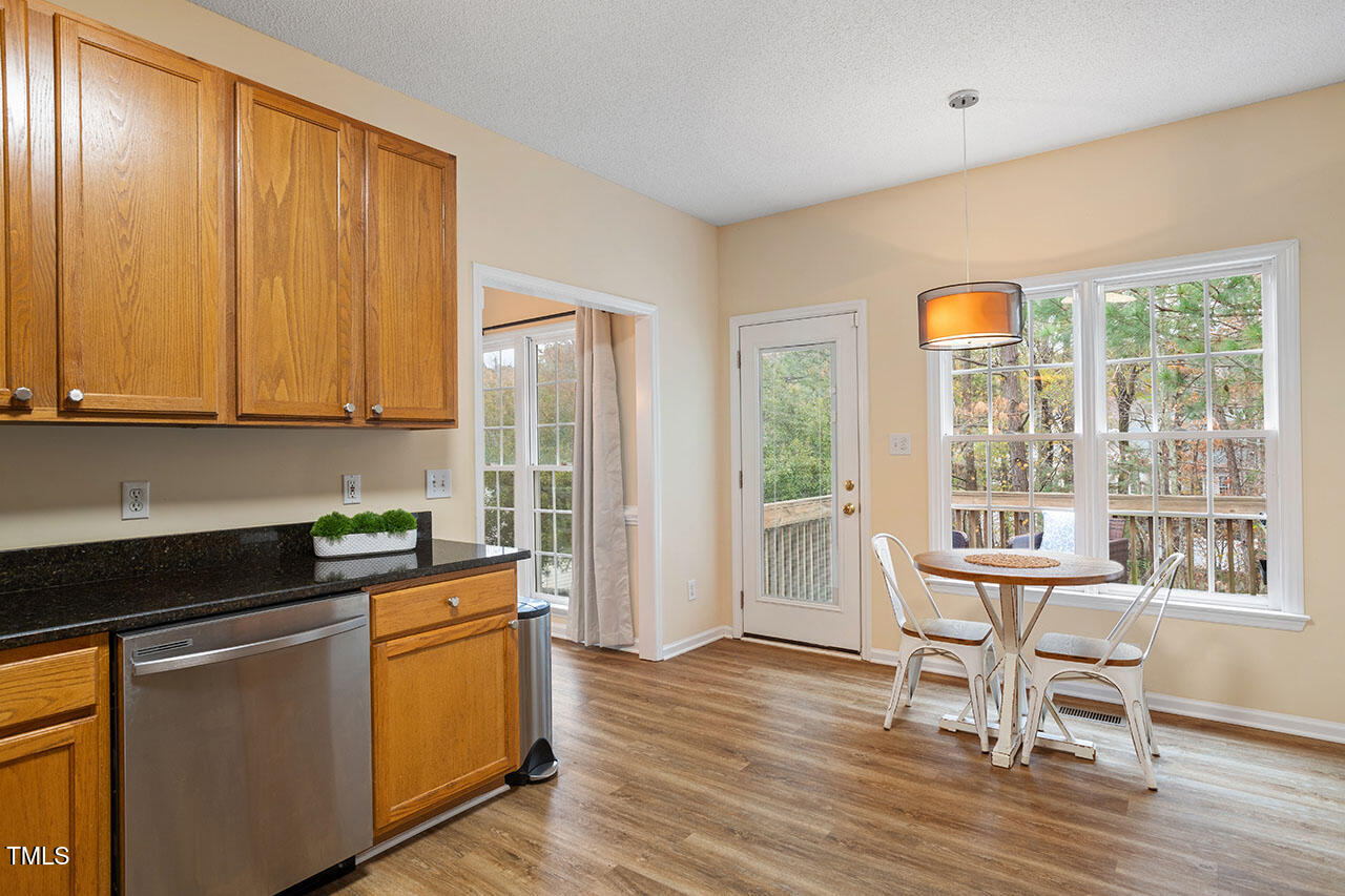 7040 Bellard Court Raleigh, NC 27617 - Photo 14 of 31 a kitchen that has a sink and a table in it