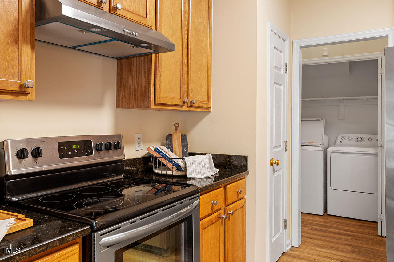7040 Bellard Court Raleigh, NC 27617 - Photo 15 of 31 a kitchen with a stove and a refrigerator