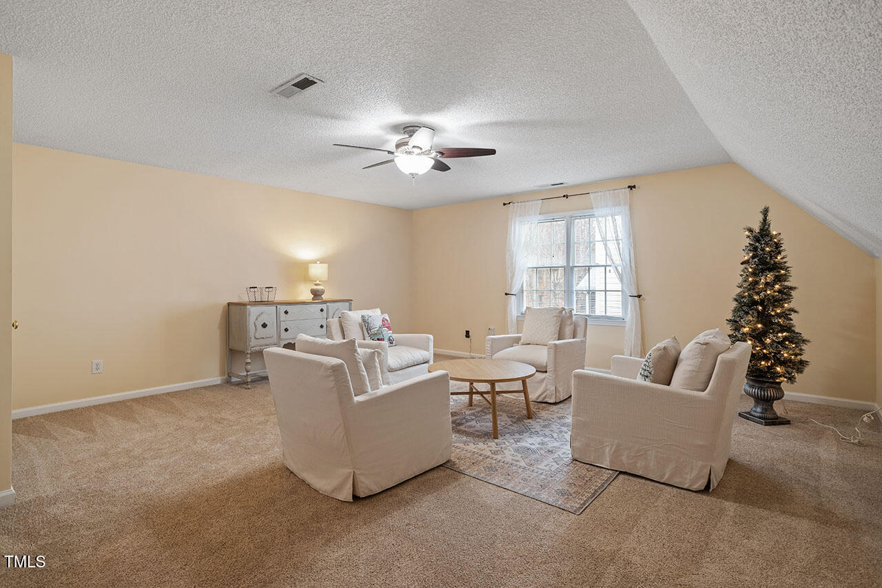 7040 Bellard Court Raleigh, NC 27617 - Photo 20 of 31 a living room with furniture and a large window