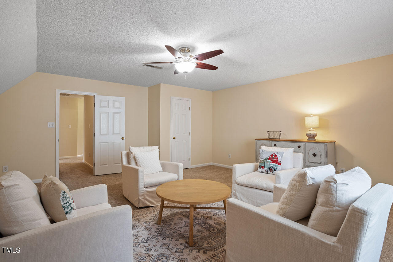 7040 Bellard Court Raleigh, NC 27617 - Photo 21 of 31 a living room with furniture and a table