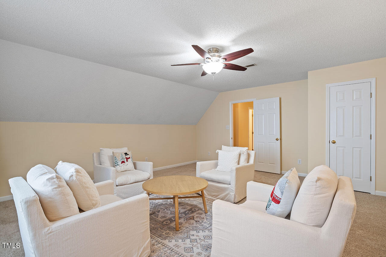 7040 Bellard Court Raleigh, NC 27617 - Photo 22 of 31 a living room with furniture and a large window