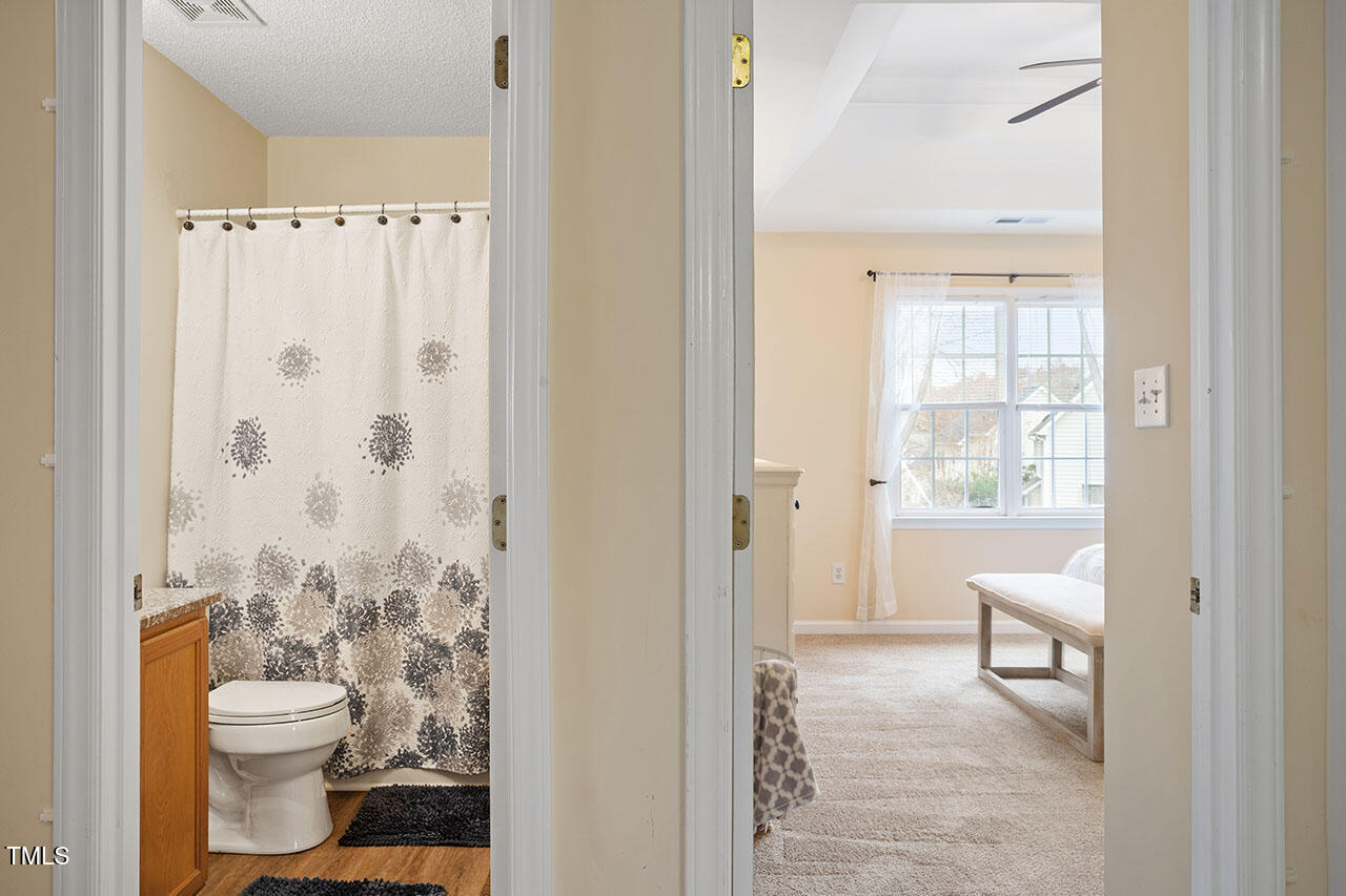 7040 Bellard Court Raleigh, NC 27617 - Photo 23 of 31 a bathroom with a toilet a sink and a shower