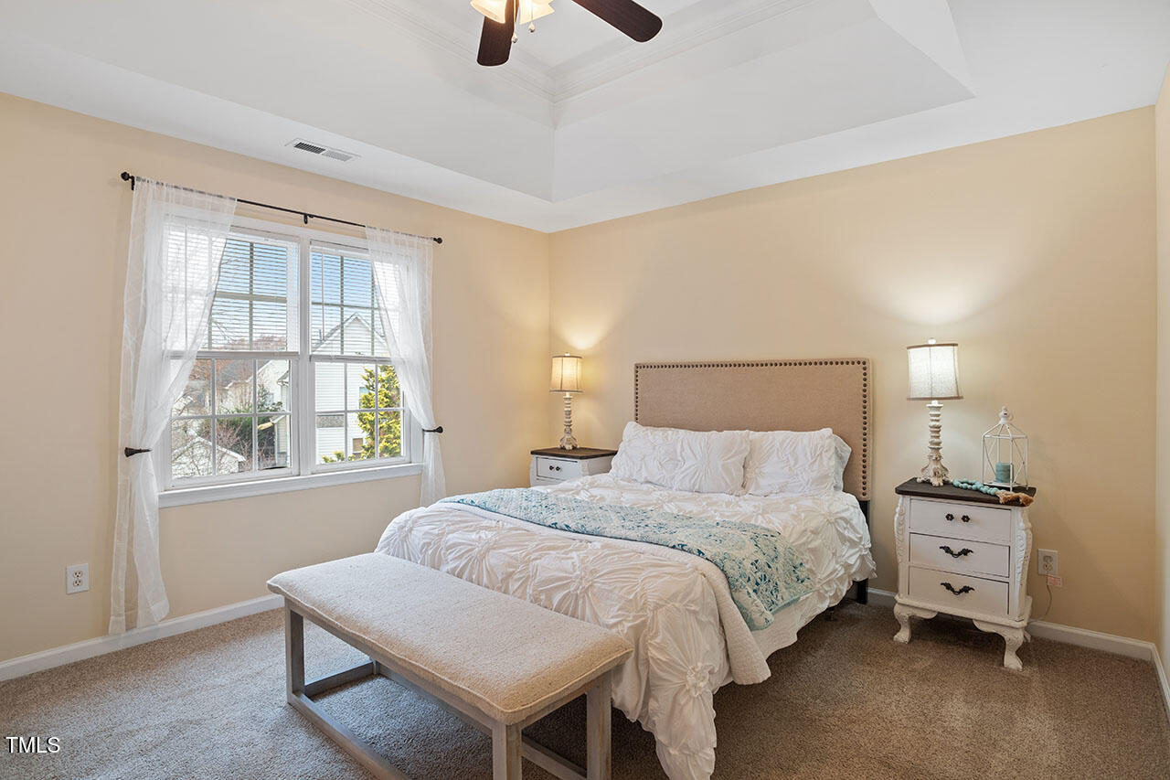 7040 Bellard Court Raleigh, NC 27617 - Photo 24 of 31 a bedroom with a bed and window