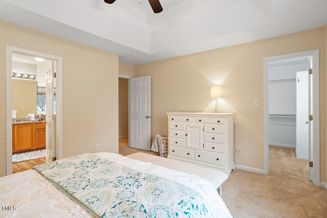 7040 Bellard Court Raleigh, NC 27617 - Photo 25 of 31 a bedroom with a bed and cabinets