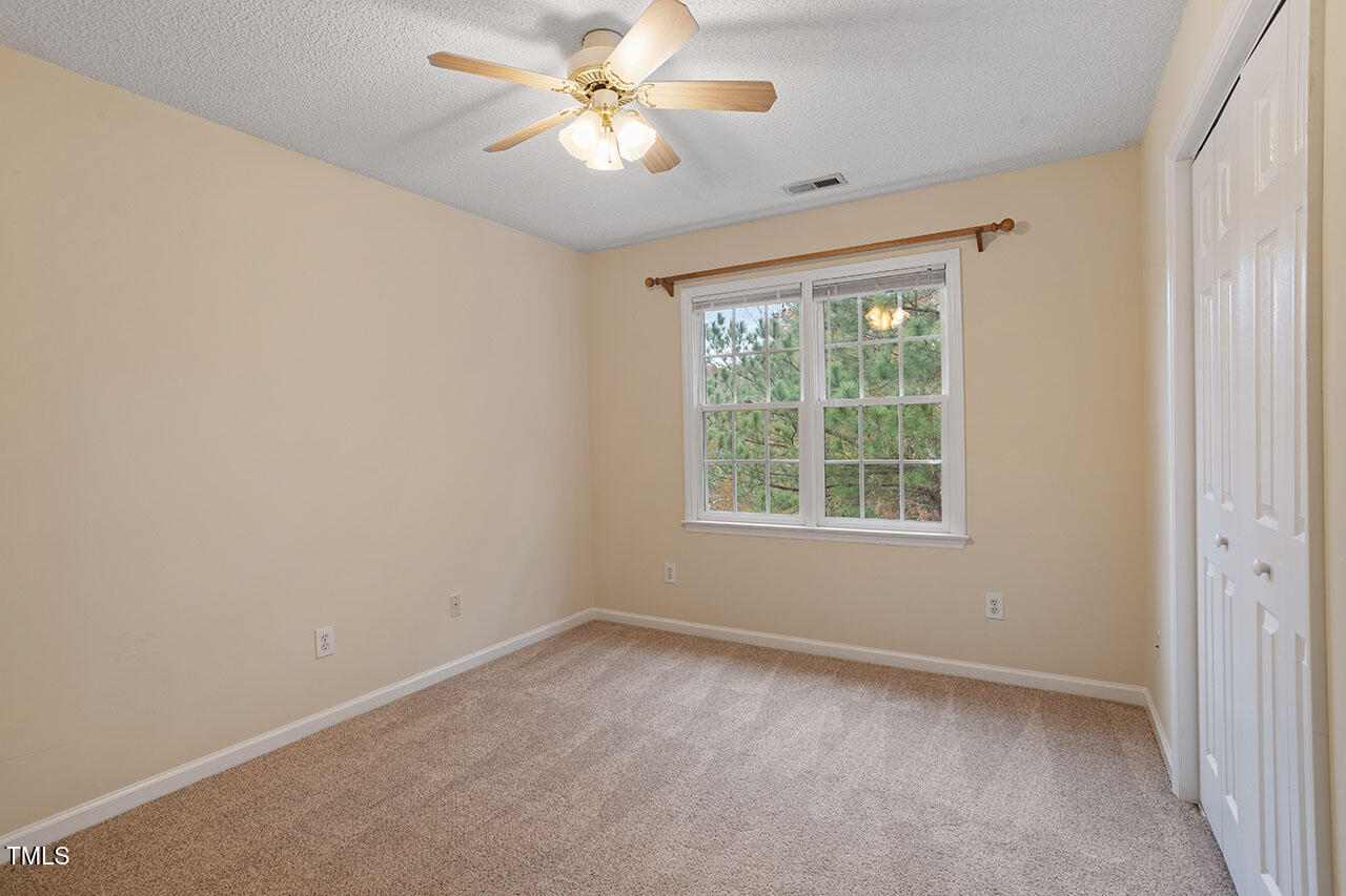 7040 Bellard Court Raleigh, NC 27617 - Photo 29 of 31 an empty room with a window and a fan
